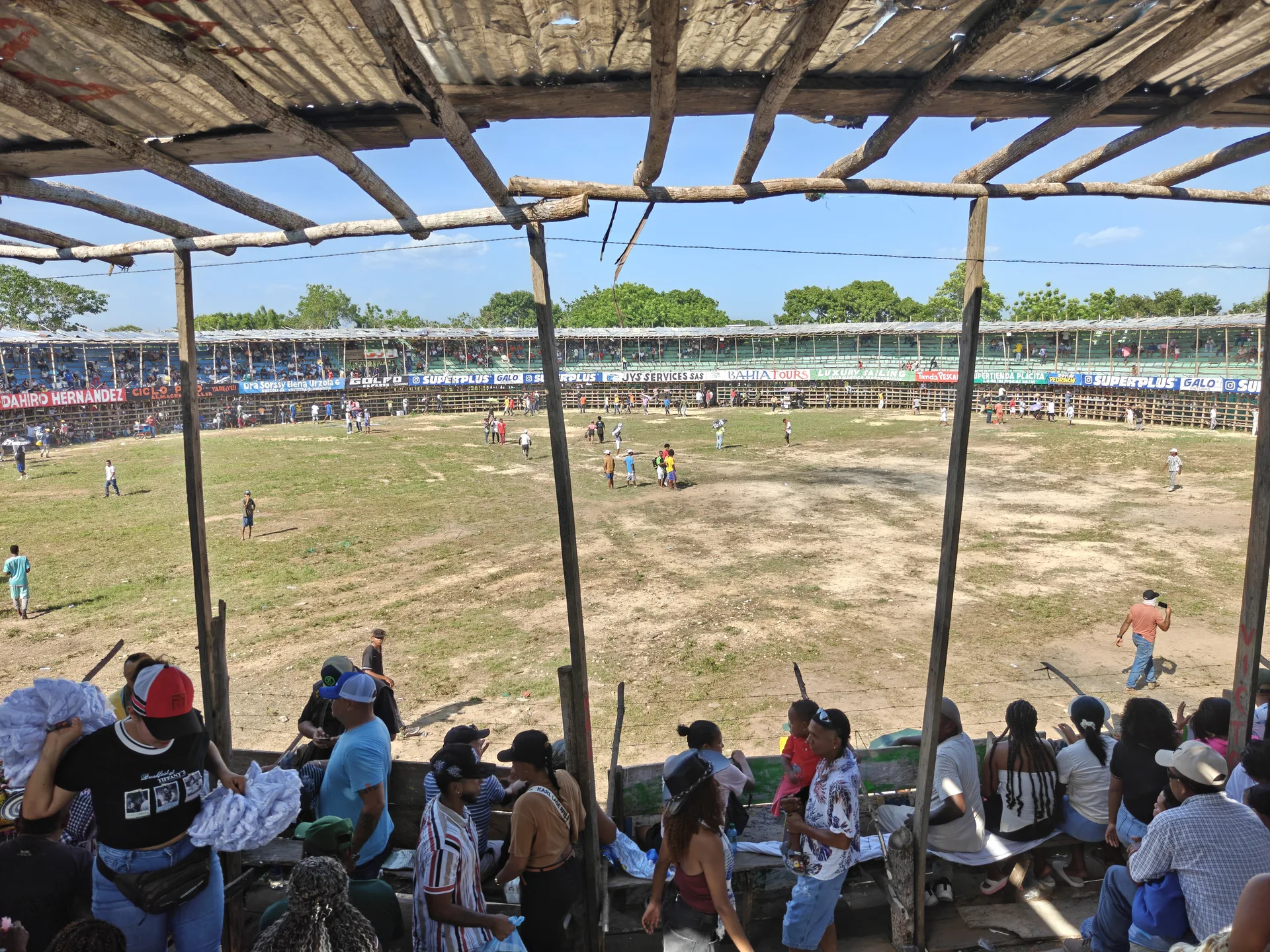 The corraleja in Tolú, the dirt ruedo below and the wooden palcos packed above.