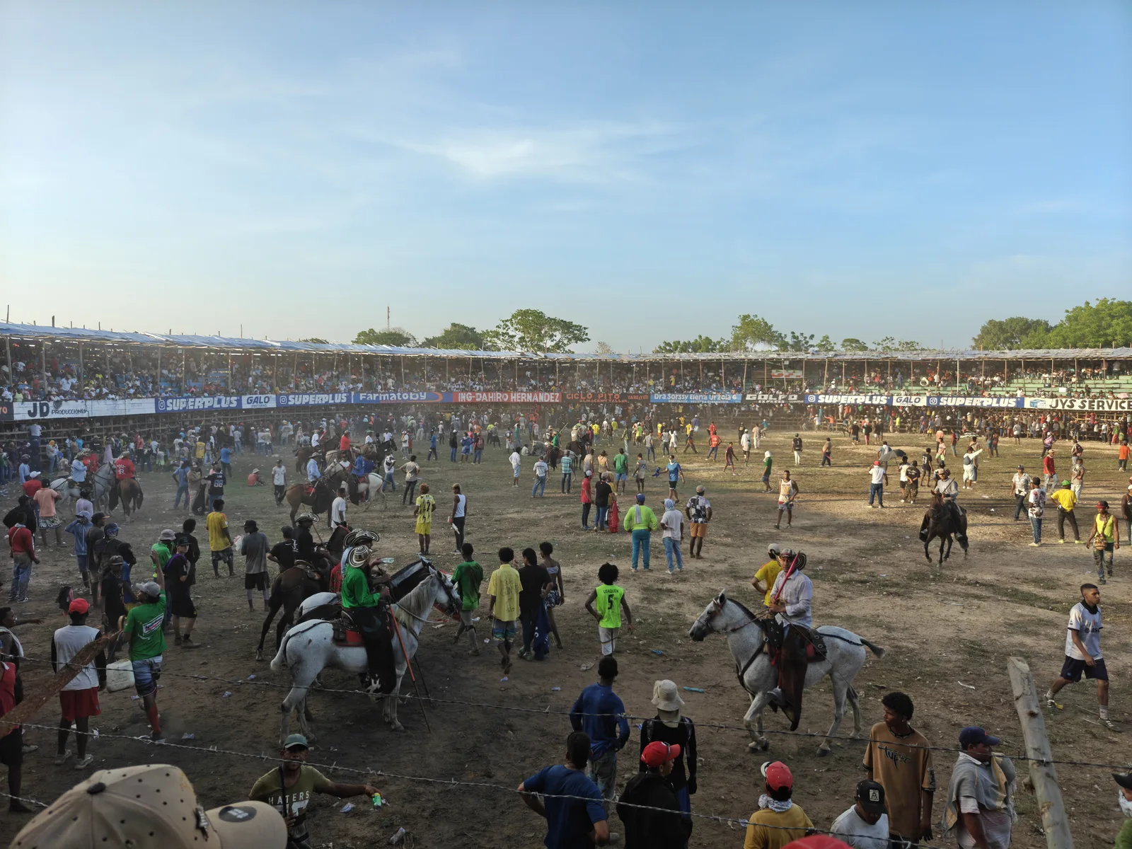 Garrocheros work the ruedo on horseback.