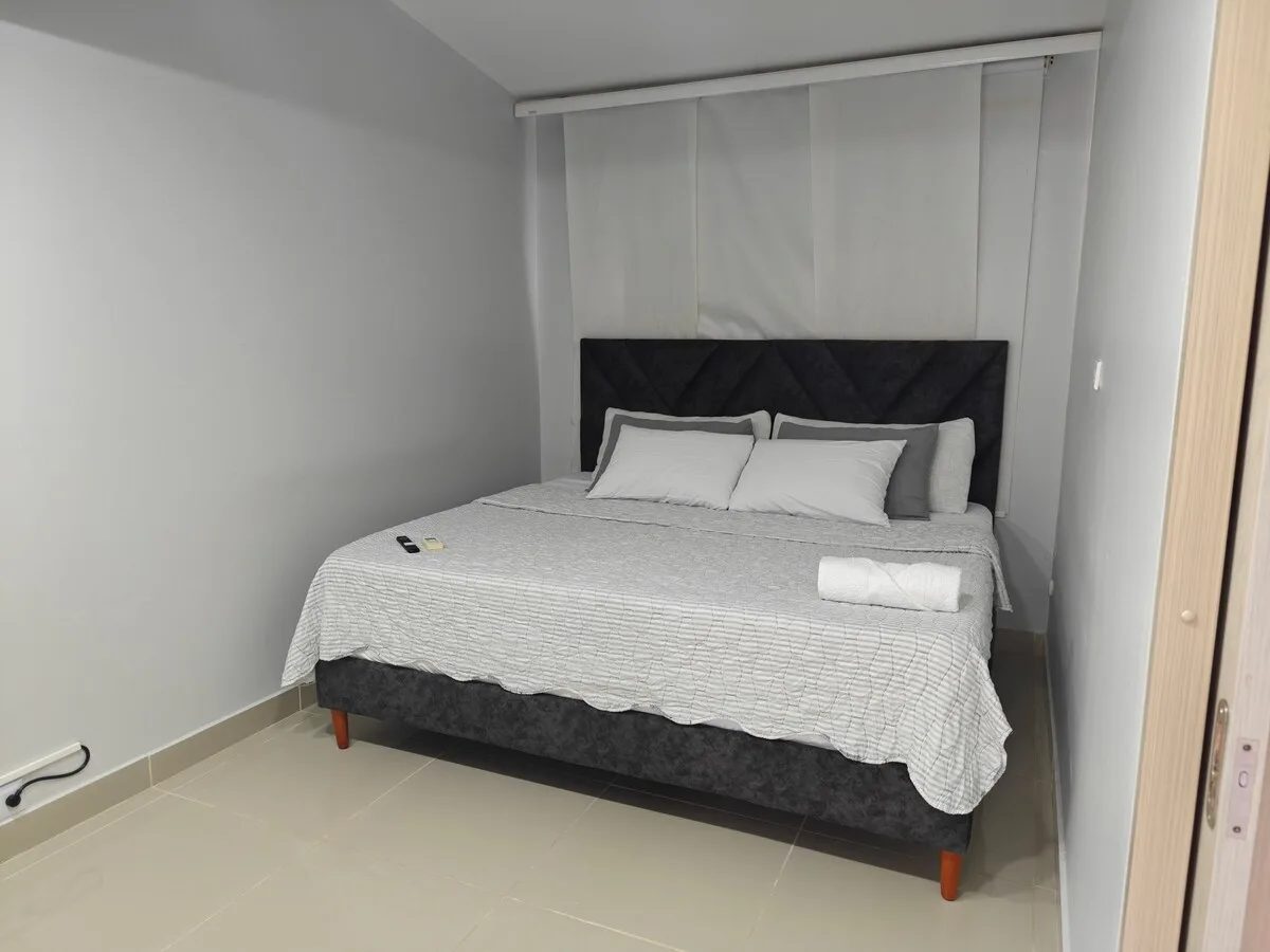 Third bedroom with dark headboard