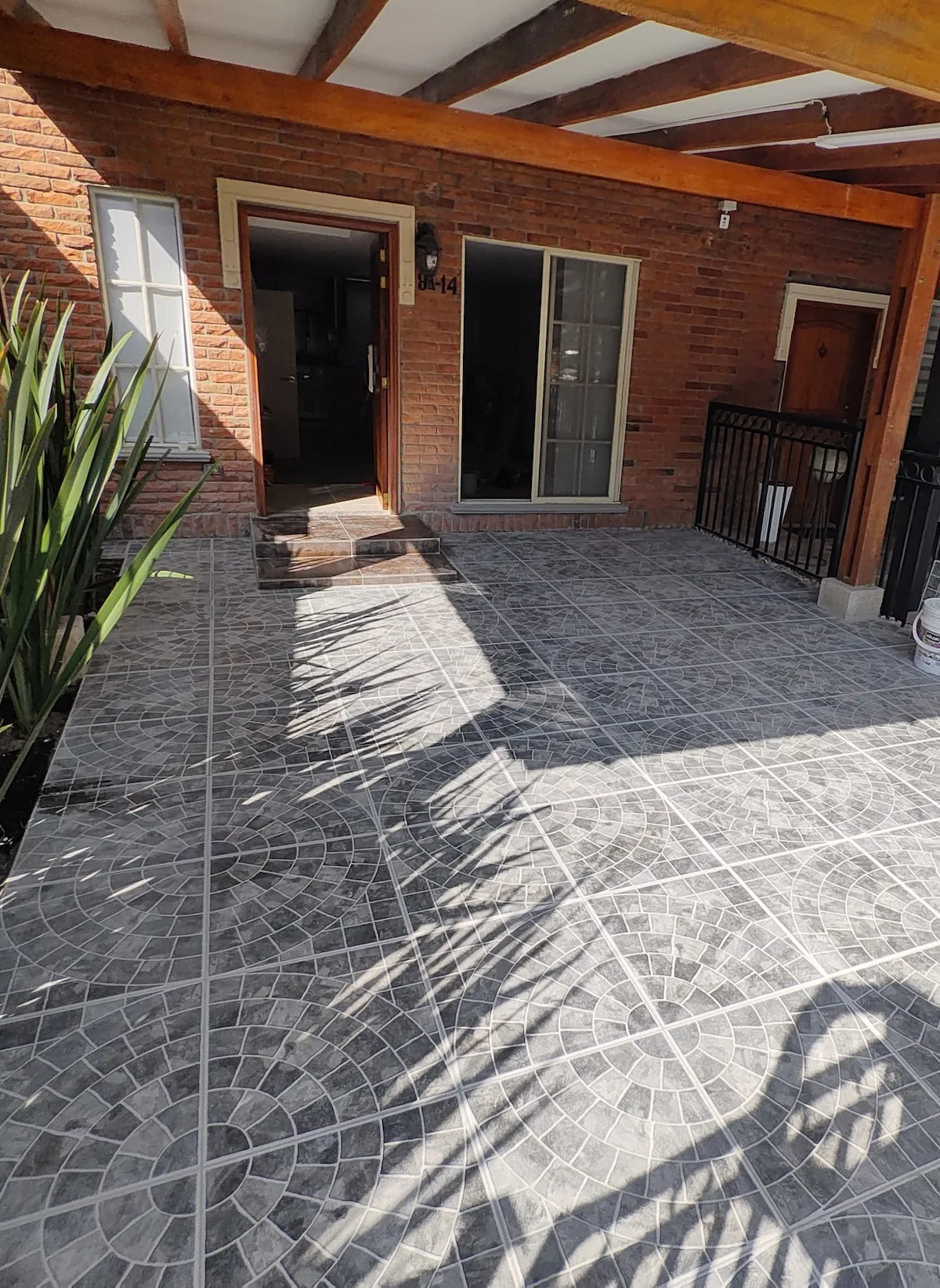 Brick townhome facade with covered porch parking in Pinares, Pereira