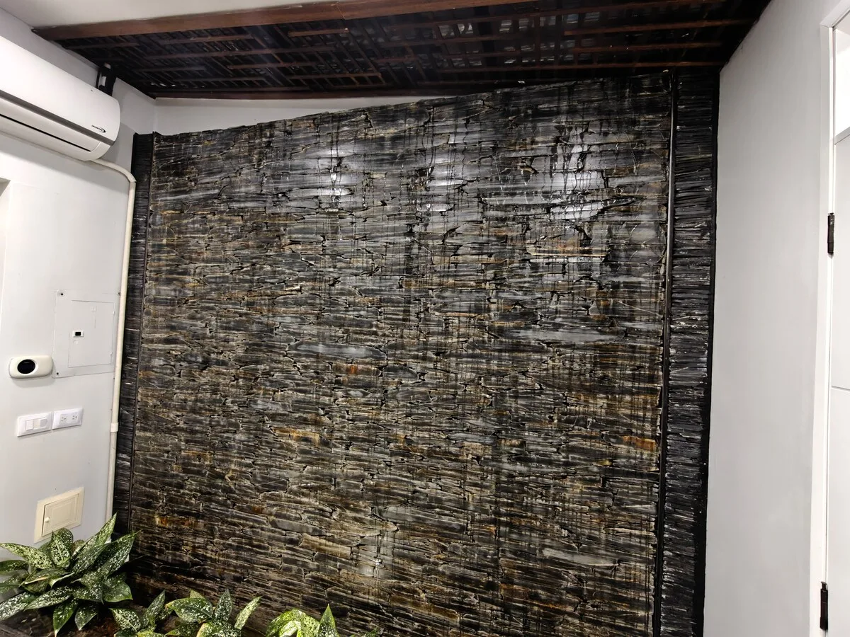 Textured stone feature wall behind the TV
