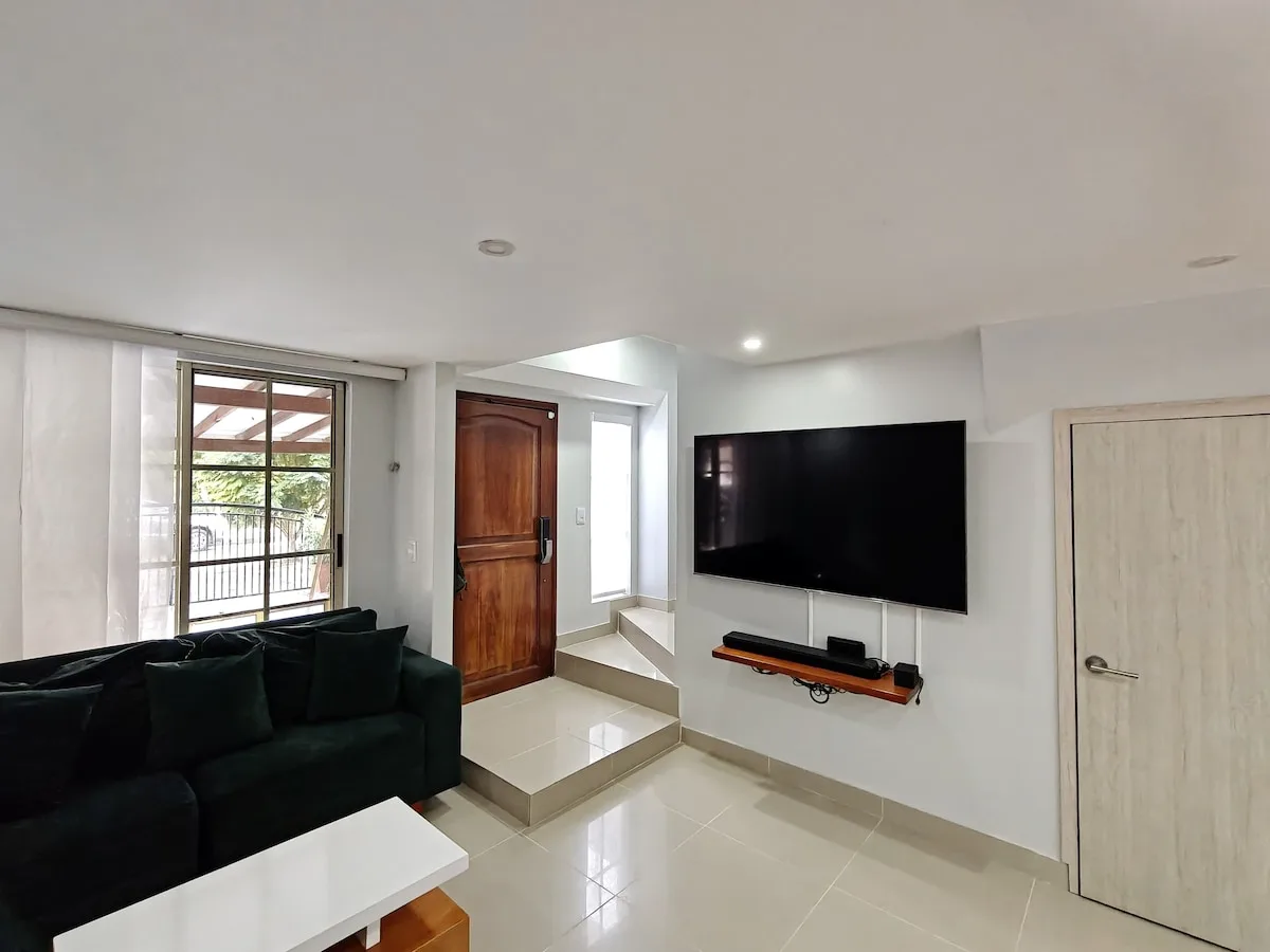 Living area with wall-mounted TV and sofa